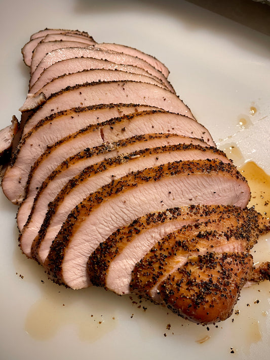 Smoked turkey breast sliced fresh with peppered bark exterior . Shipping Nationwide